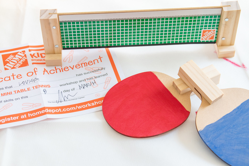 A finished table tennis kit with a certificate of achievement on a table.