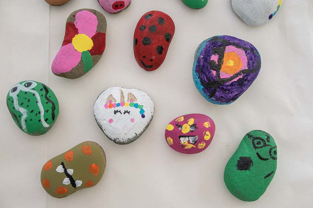 An assortment of small, colorful painted rocks.