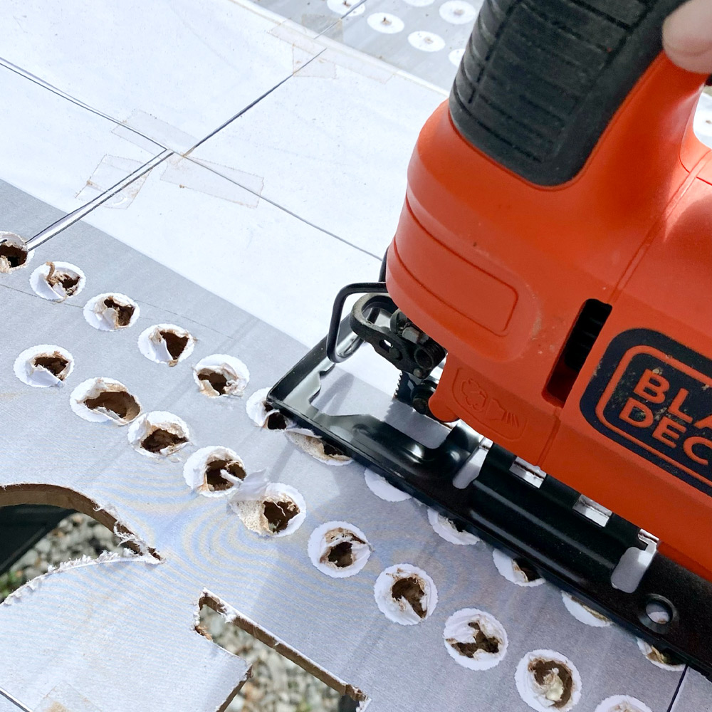 Jigsaw being used to cut the MDF board.
