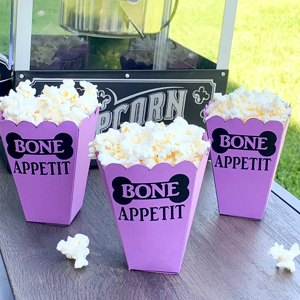 Custom purple filled popcorn containers.