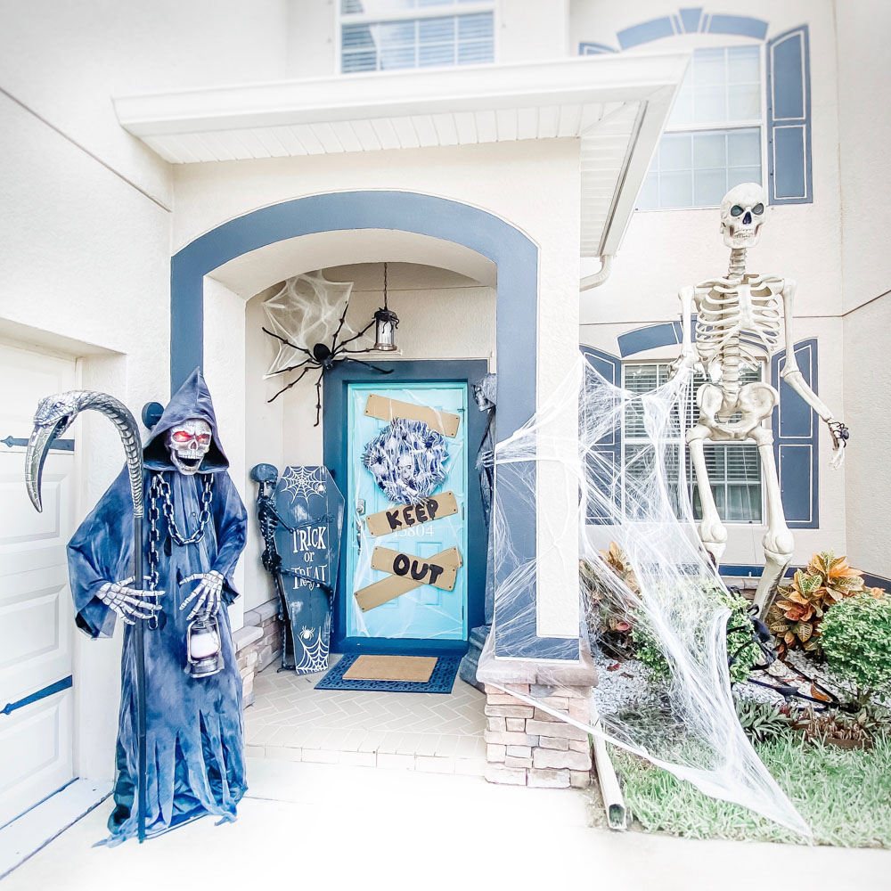 A spooky cemetery front porch decorated for Halloween.