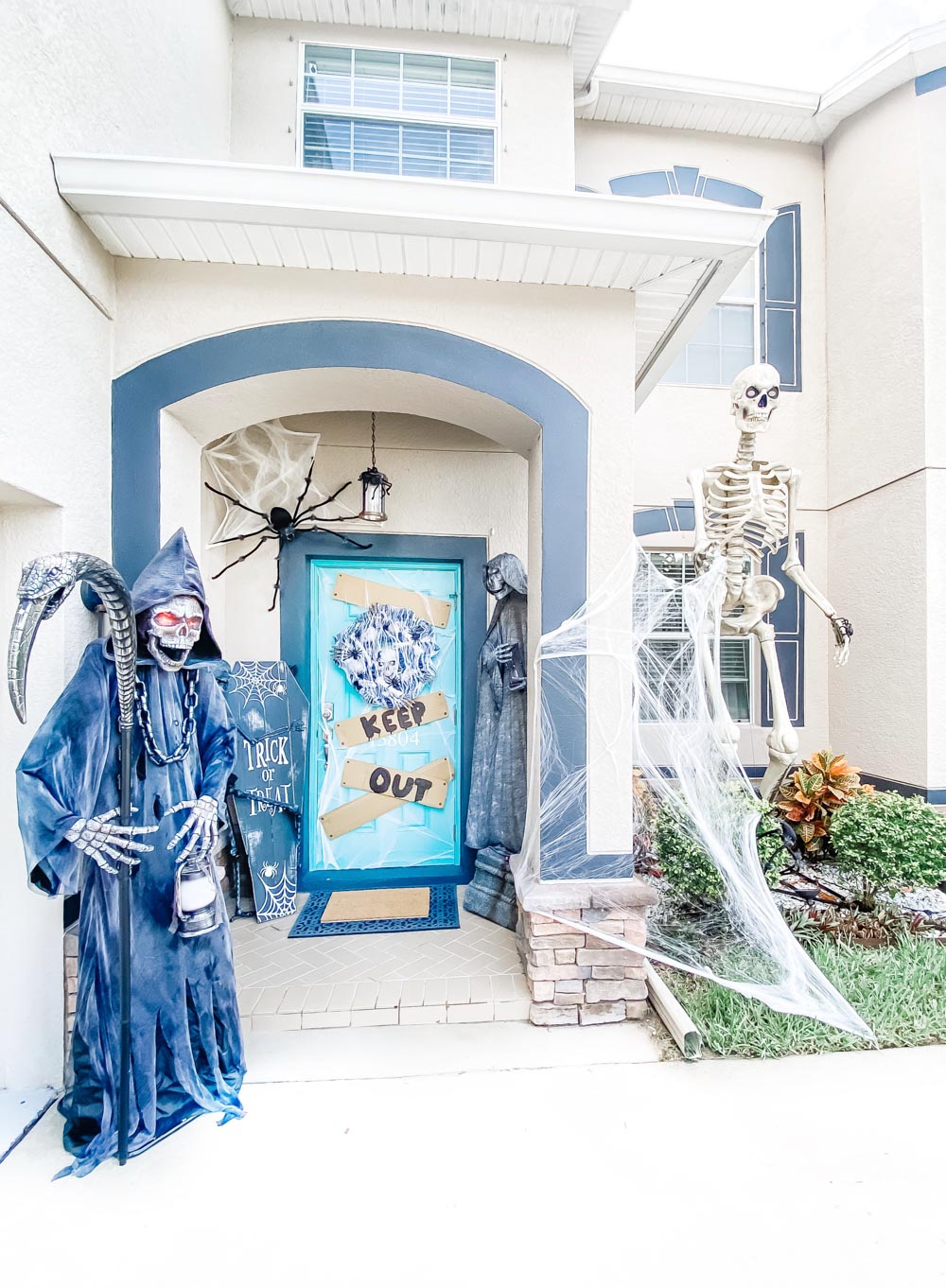 A Halloween front porch decorated as a spooky cemetery.