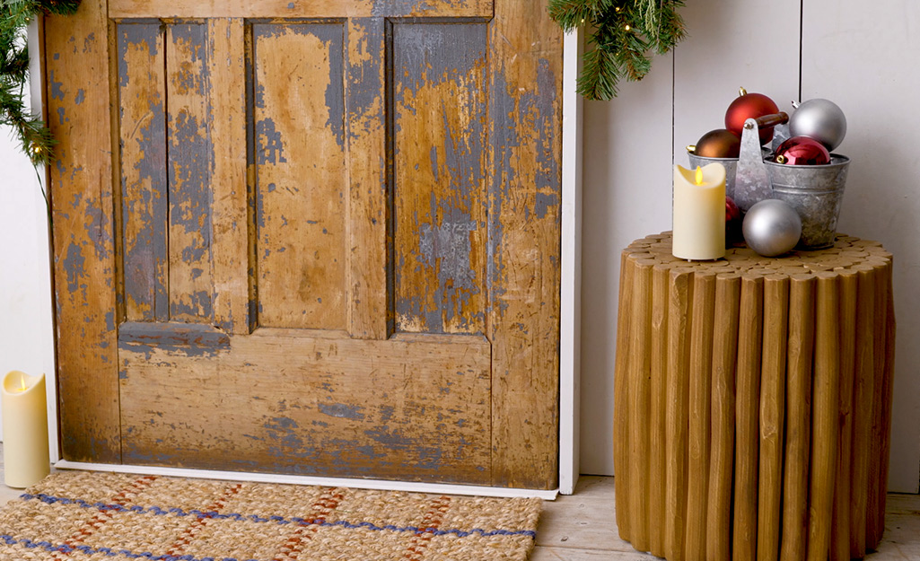 A festive door complete with garland, flameless candles, ornaments and more.