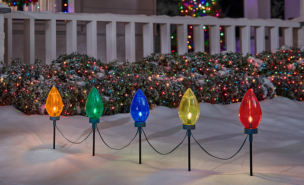 Bulb-shaped lights lining a sidewalk.