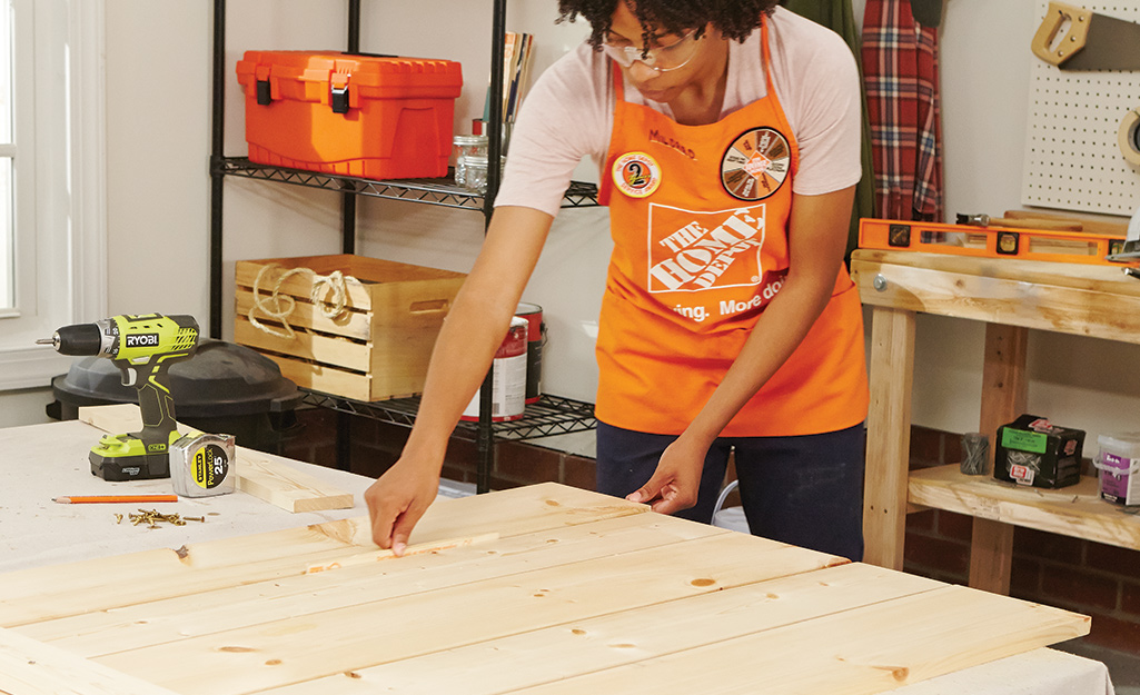 a woman assembling pieces of plywood together a woman assembling pieces of plywood together
