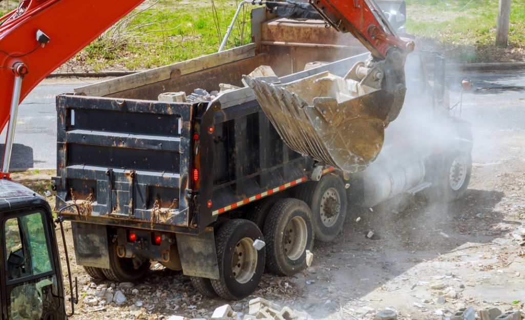 Demolished concrete is transported into a truck.