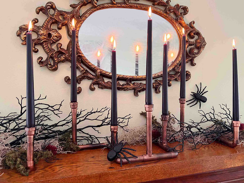 Creepy Copper Candles on a tabletop with Halloween decorations.