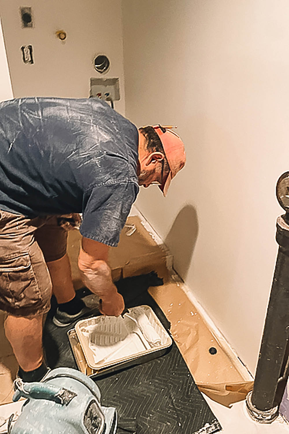 Man applying paint to paint holder. Man applying paint to paint holder.