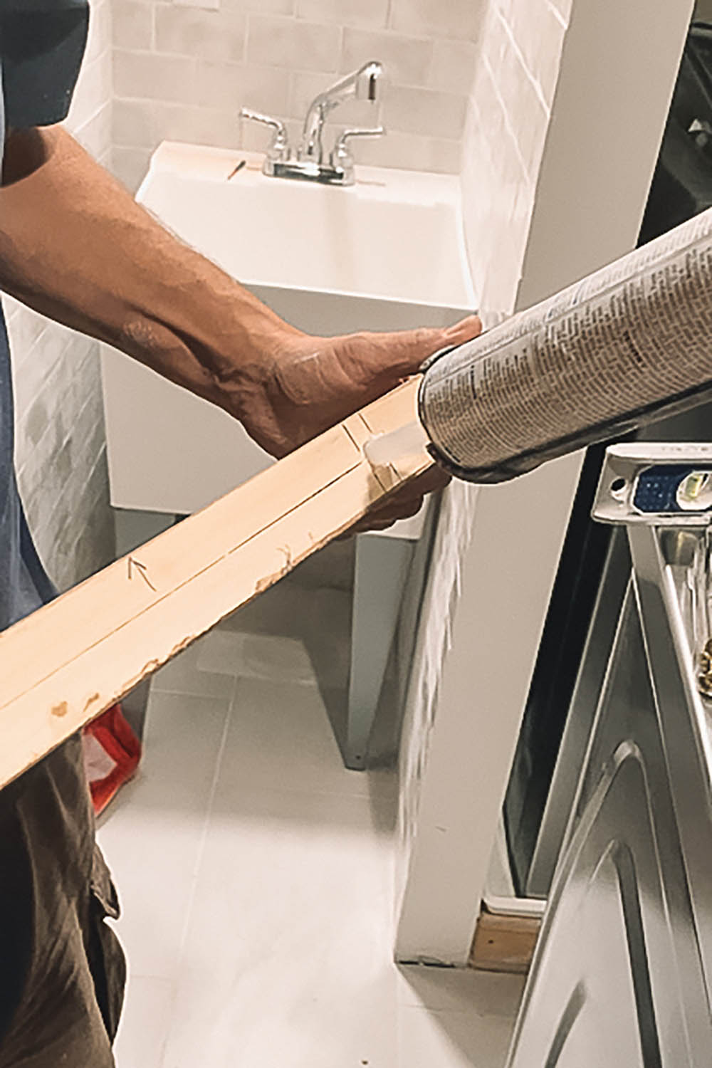 Adding Liquid nails to wood before attaching to wall. Adding Liquid nails to wood before attaching to wall.