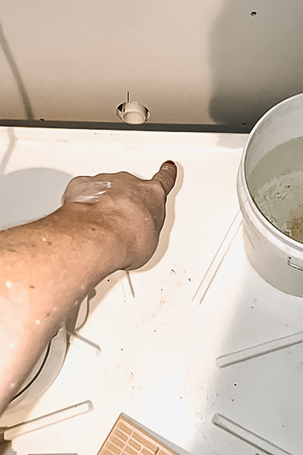 Hand showing hole drilled for washing machine leaks. Hand showing hole drilled for washing machine leaks.
