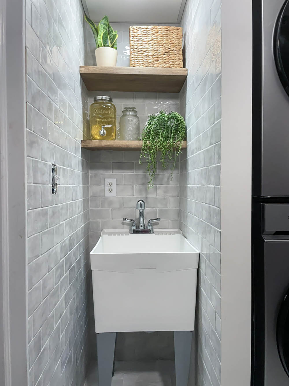 Laundry room sink and shelf with decorations. Laundry room sink and shelf with decorations.