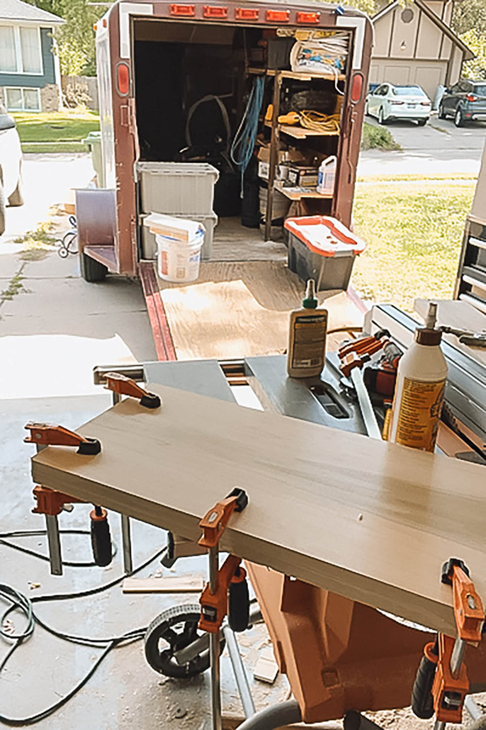Clamps holding wooden boards together so they can stick together. Clamps holding wooden boards together so they can stick together.