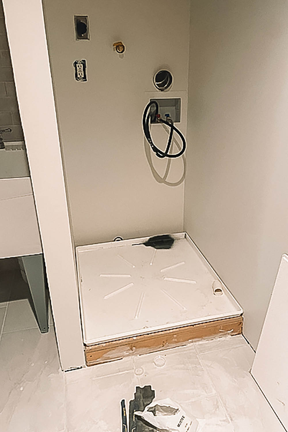 White floor platform for washer/dryer installation. White floor platform for washer/dryer installation.