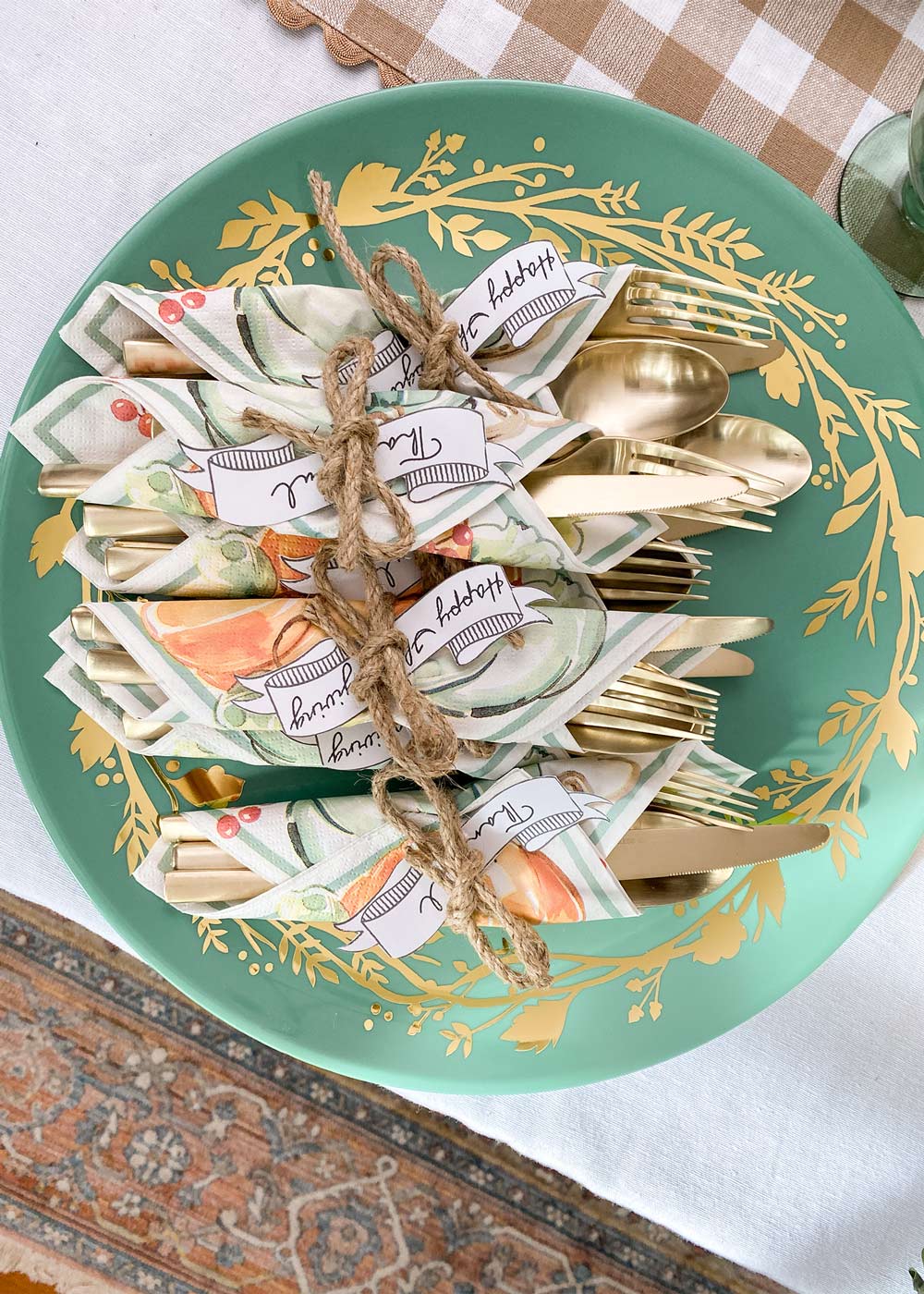 Silverware wrapped in napkins on platter.