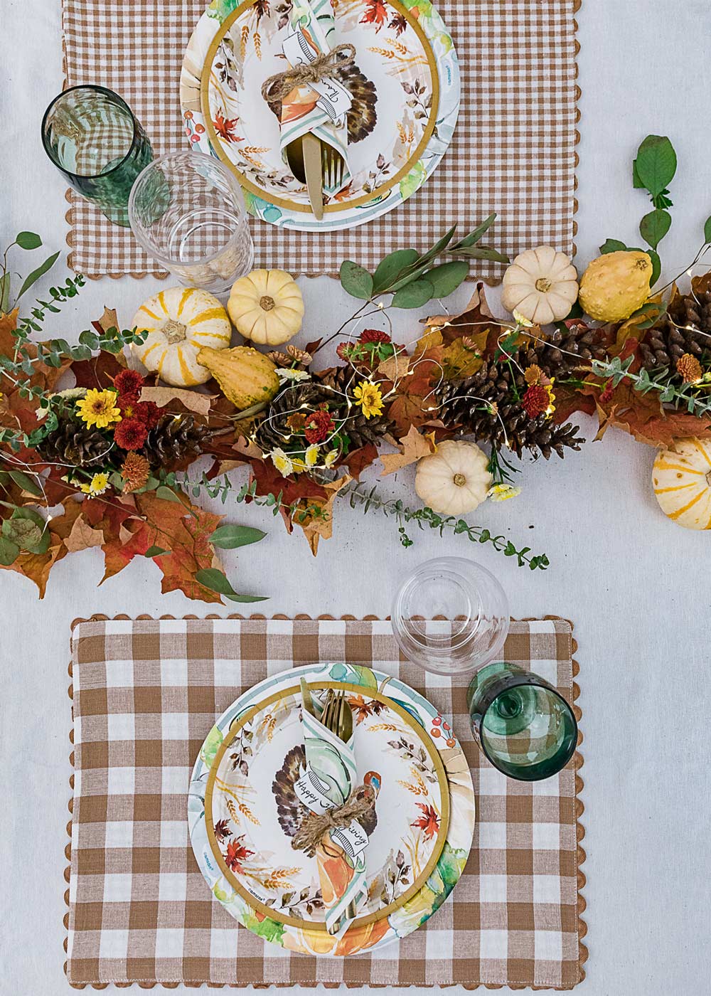Place settings and garland on Friendsgiving table. Place settings and garland on Friendsgiving table.