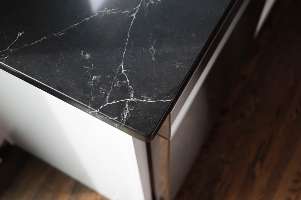 Corner of a black marble countertop.