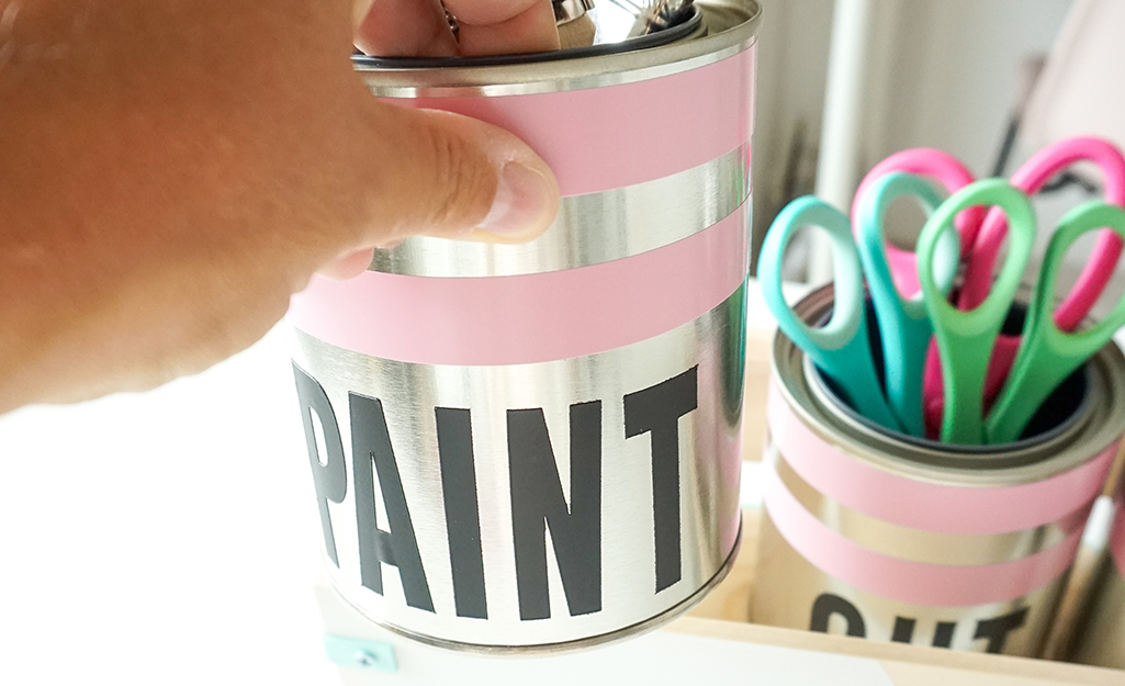 Can is filled with art supplies.