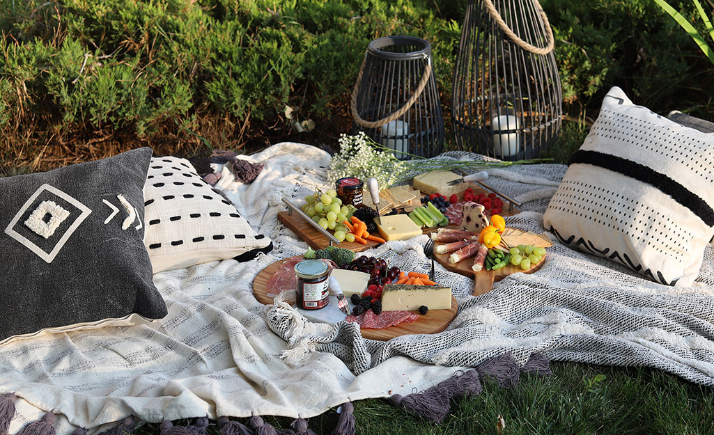 A date night picnic with three cheeseboards loaded with charcuterie