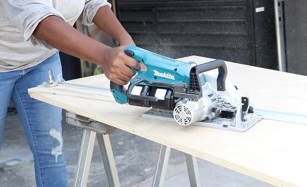 A person uses a saw to create diagonal trims for a door.