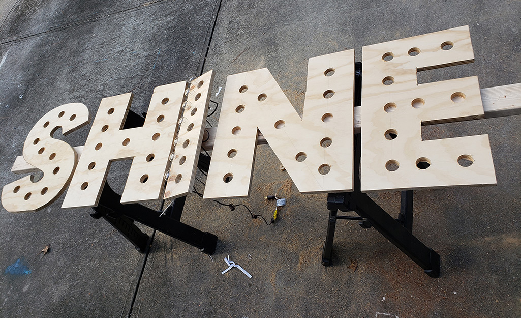 String lights inserted through the plywood letter I.