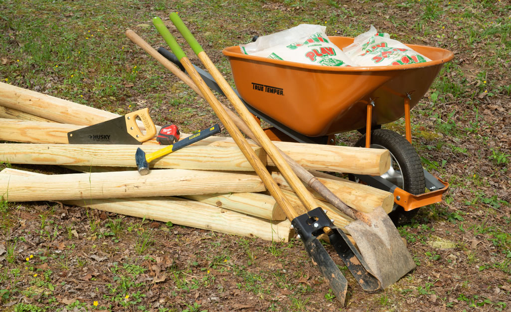 picture of wheelbarrow, lumber, shovel, saw and hammer