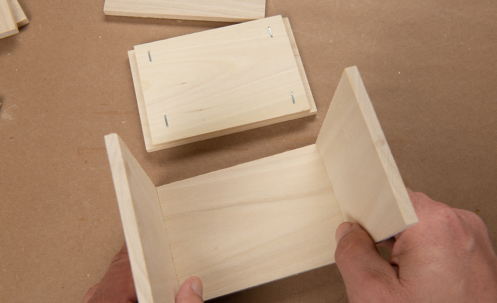 Wood is put together to form drawers.