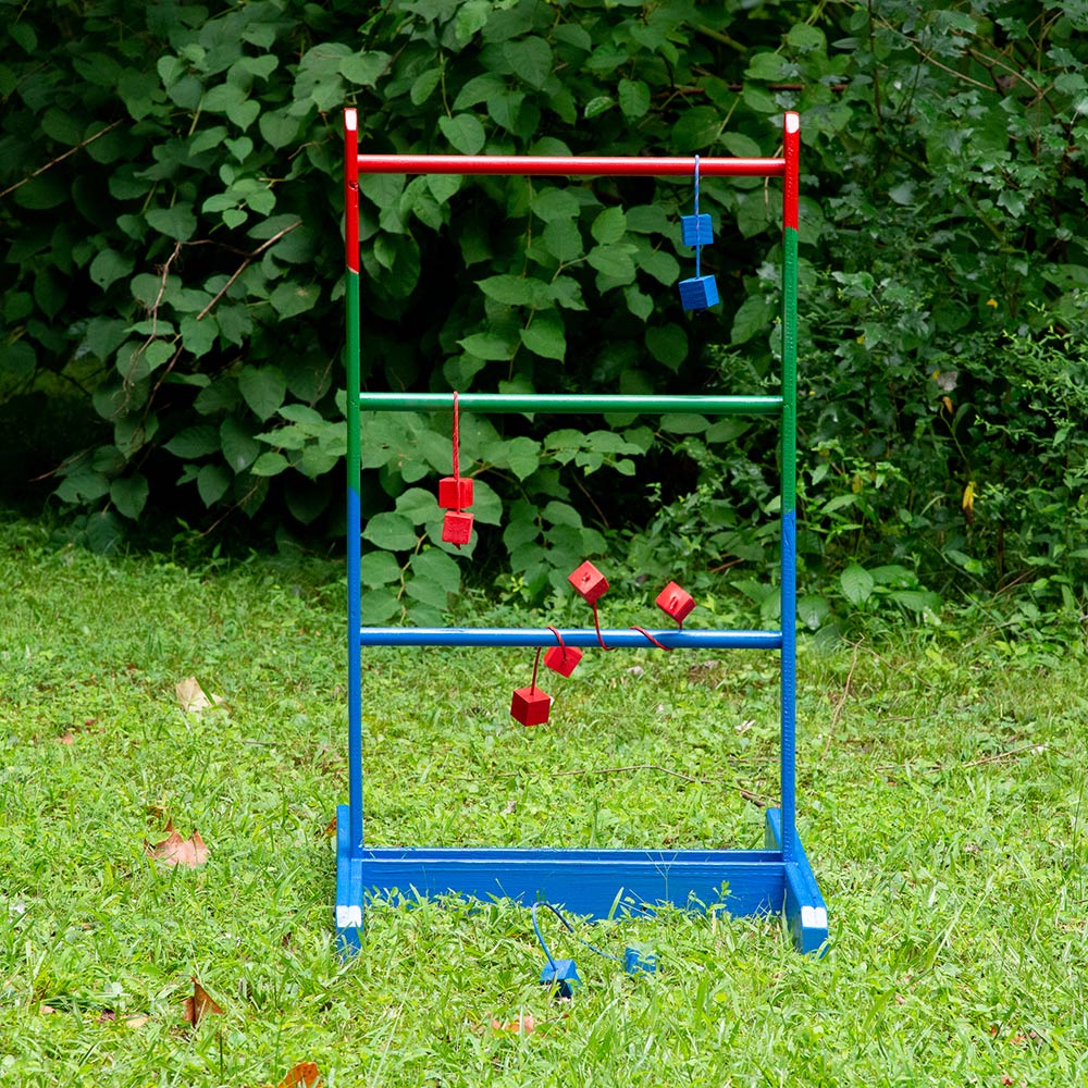 A DIY ladder golf game displayed in a yard. 