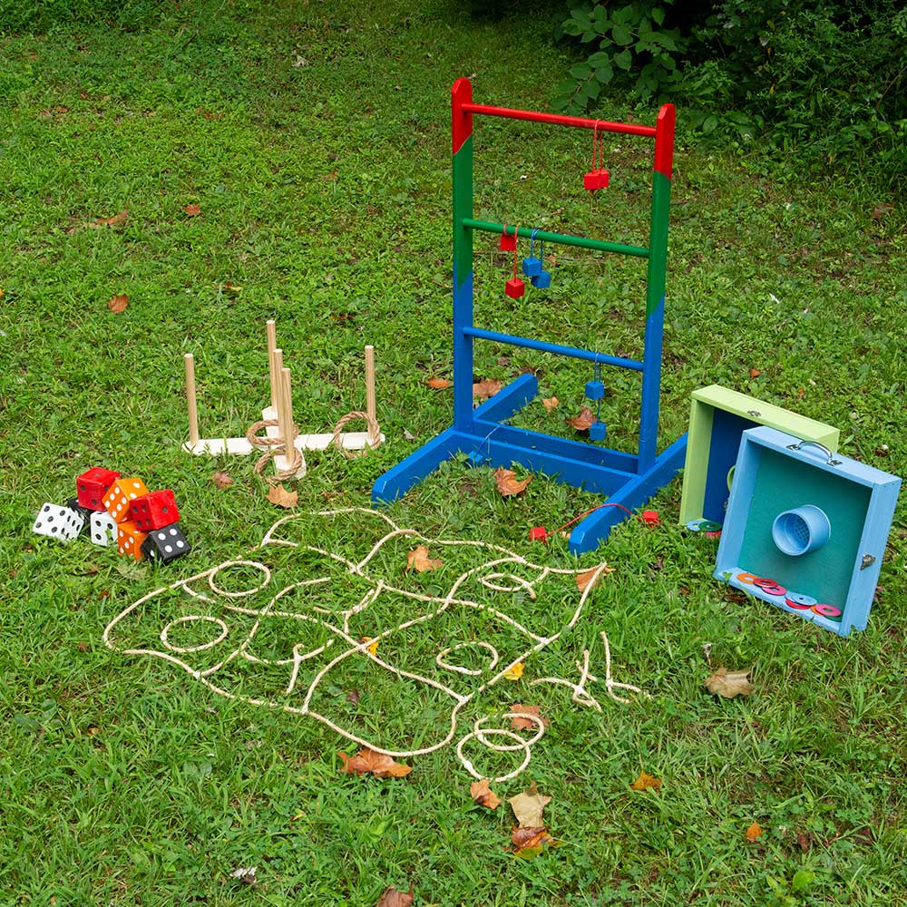 Five different types of lawn games displayed in a yard.