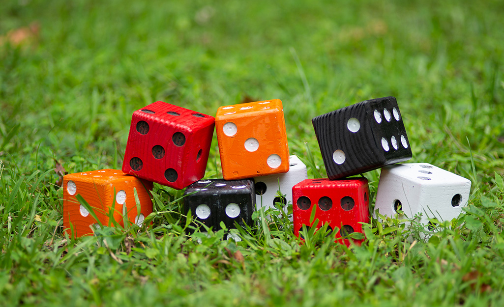 Multi-colored lawn dice displayed on a lawn.