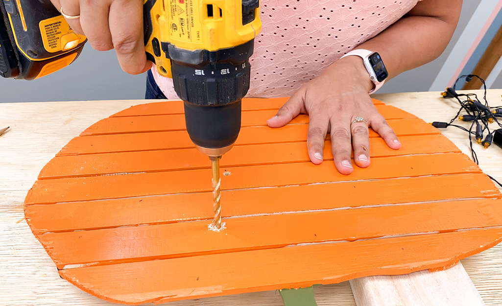 Person drilling into the pumpkin. Person drilling into the pumpkin.