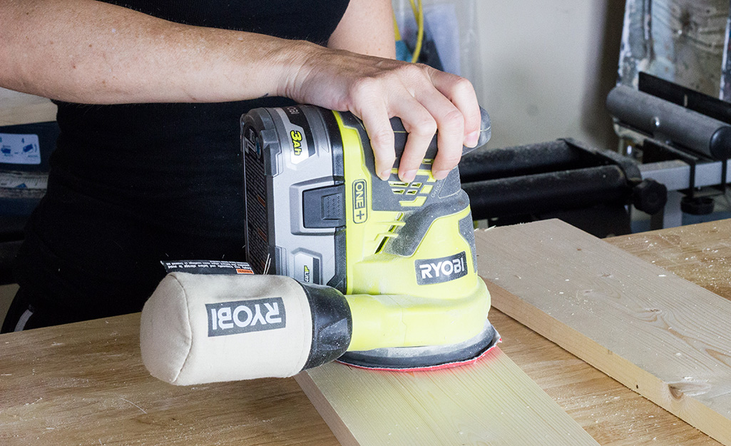 Person sanding wood.