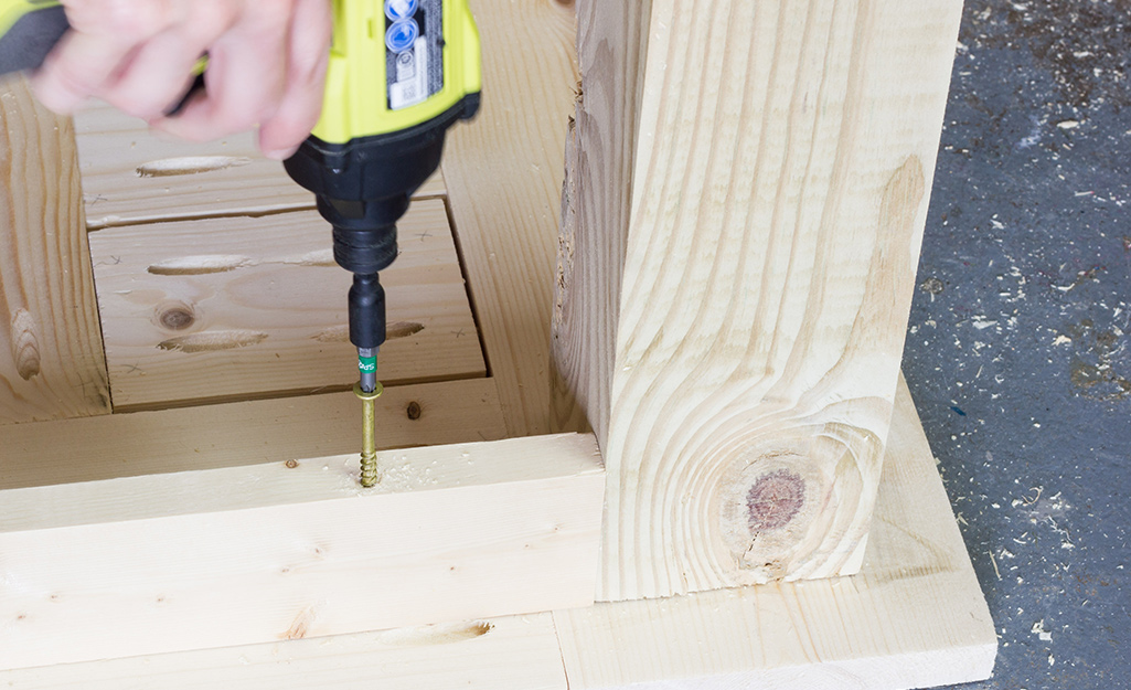Person attaching the base to the tabletop.