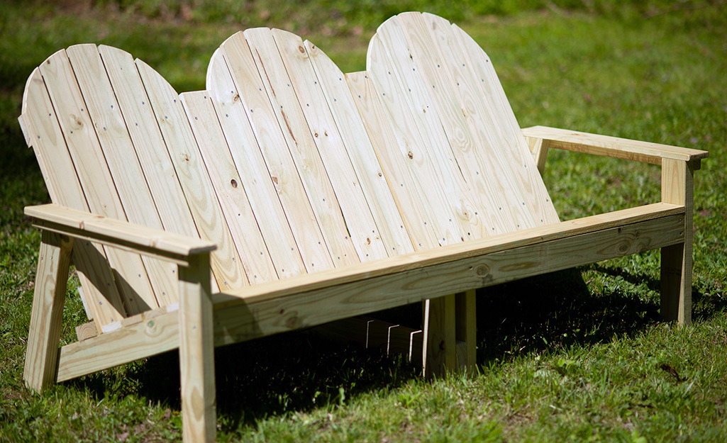 An outdoor wooden sofa.