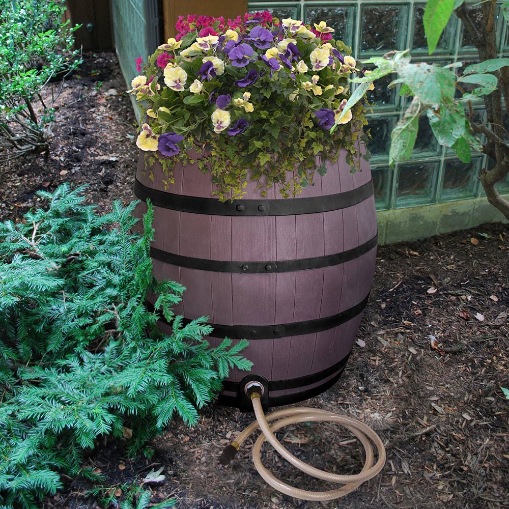 A rain barrel in a garden.