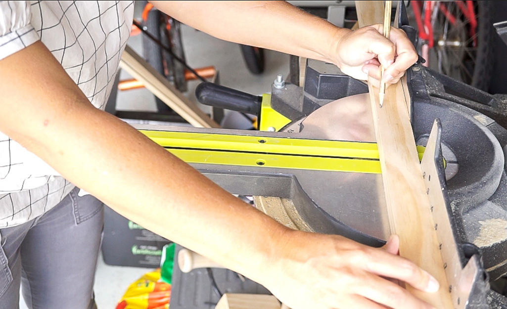 Person measures the wood. Person measures the wood.