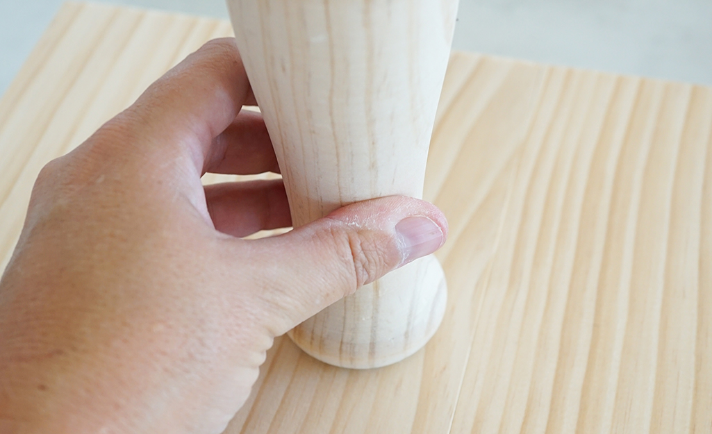 Person attaches the leg. Person attaches the leg.
