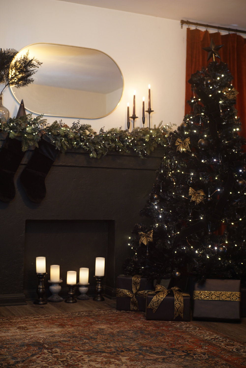 A living room area decorated with dark Christmas decorations.