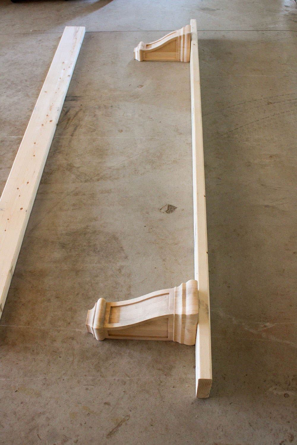 An assembled DIY large wood shelf on a concrete floor.