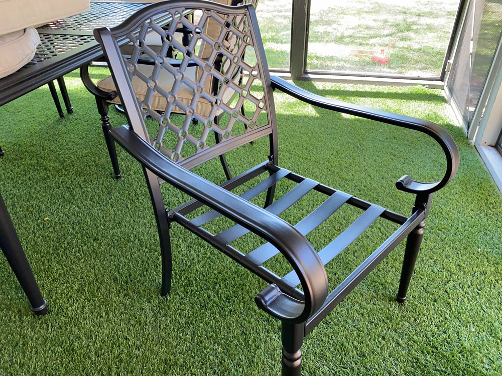 An assembled non-swiveling patio chair frame. An assembled non-swiveling patio chair frame.