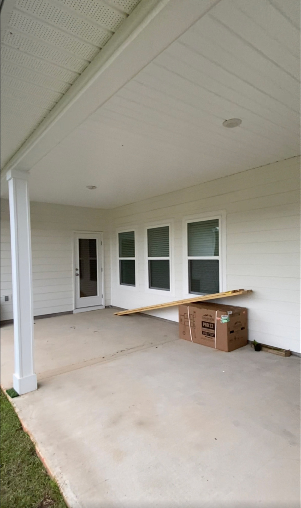 Empty patio space with a box, with lumber on top. Empty patio space with a box, with lumber on top.