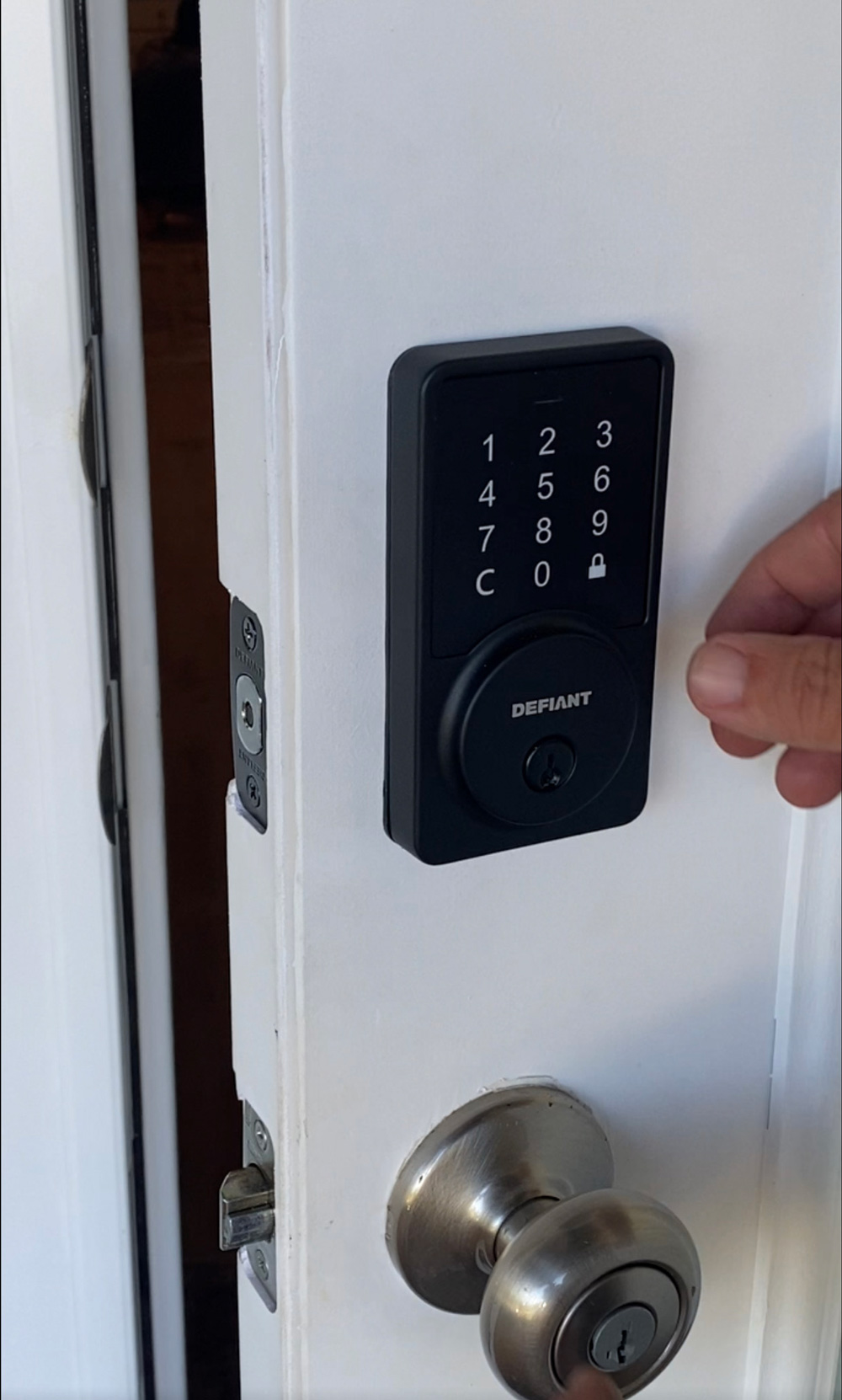 A Defiant keypad lock installed on a white door. A Defiant keypad lock installed on a white door.