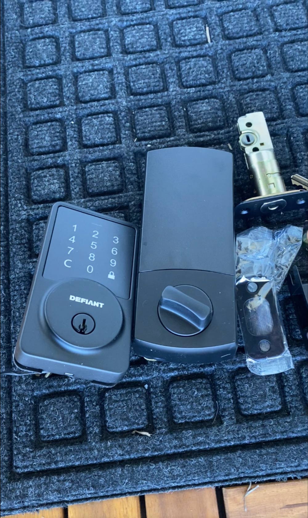 A Defiant Keypad lock set on a mat. A Defiant Keypad lock set on a mat.