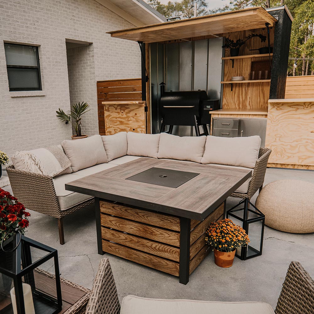A completely decorated patio, featuring a sectional, grilling station, and potted plants. A completely decorated patio, featuring a sectional, grilling station, and potted plants.