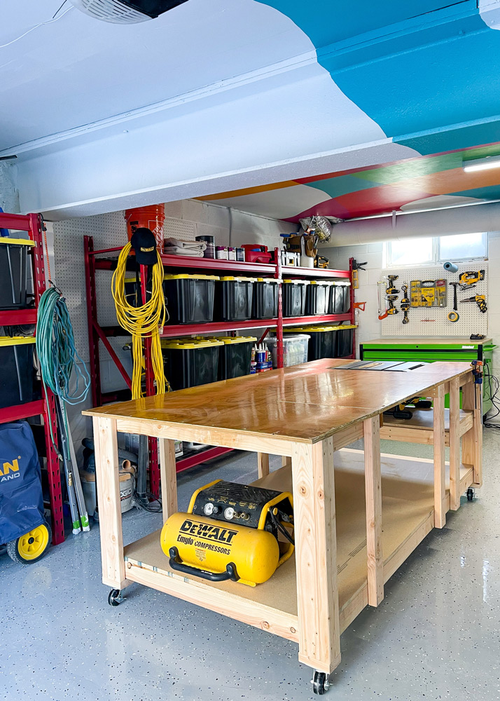 Workbench in center of the garage with red shelves in the background. Workbench in center of the garage with red shelves in the background.