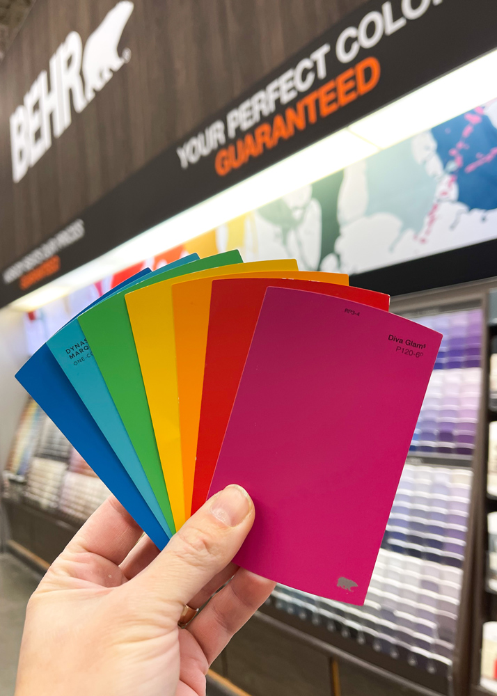 Hand holding BEHR Paint swatches. Hand holding BEHR Paint swatches.
