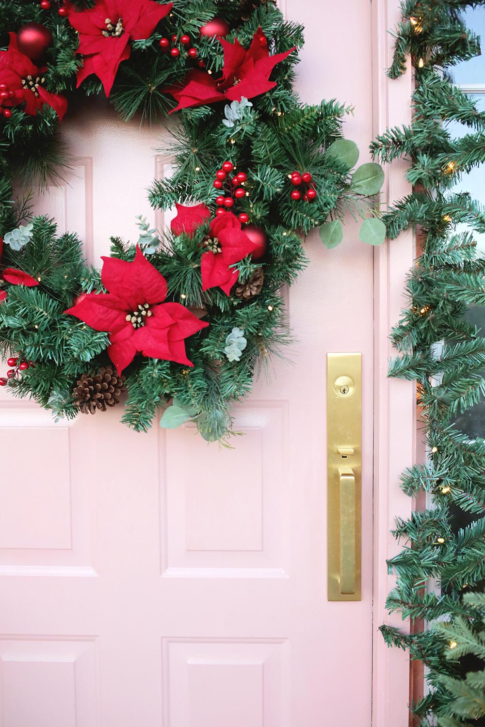 A close up shot of the decorated front door, featuring a vibrant wreath.