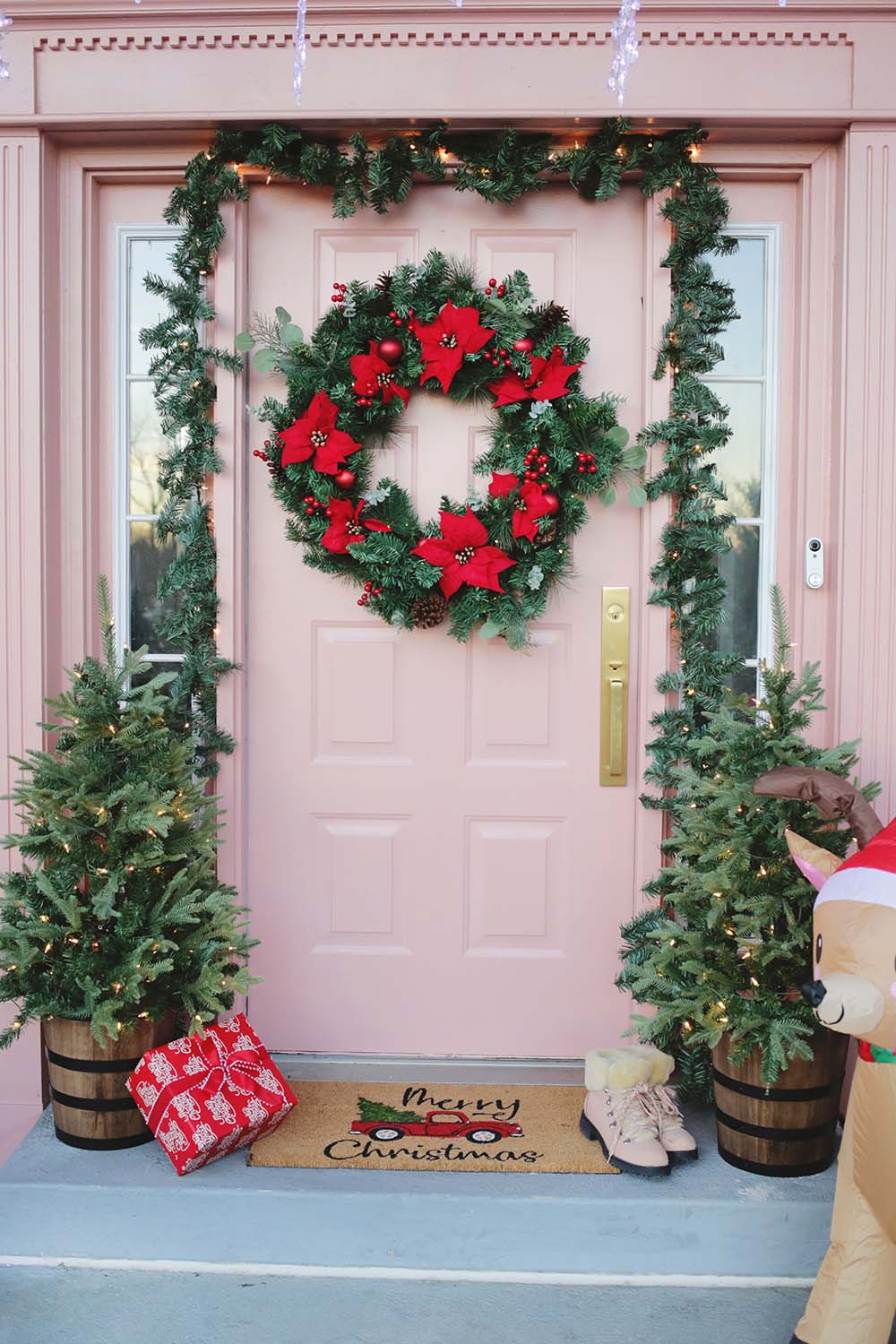 A photo of a front door decorated with Holiday decor.