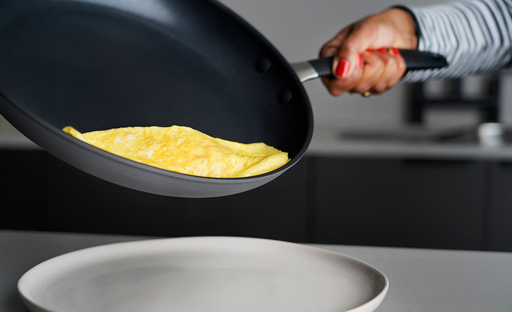 An egg is cooked in a non-stick frying pan. 