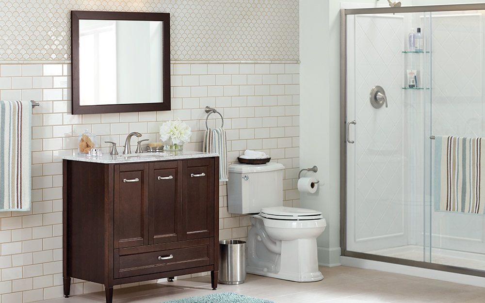 A bathroom showing a vanity, mirror, toilet and shower.