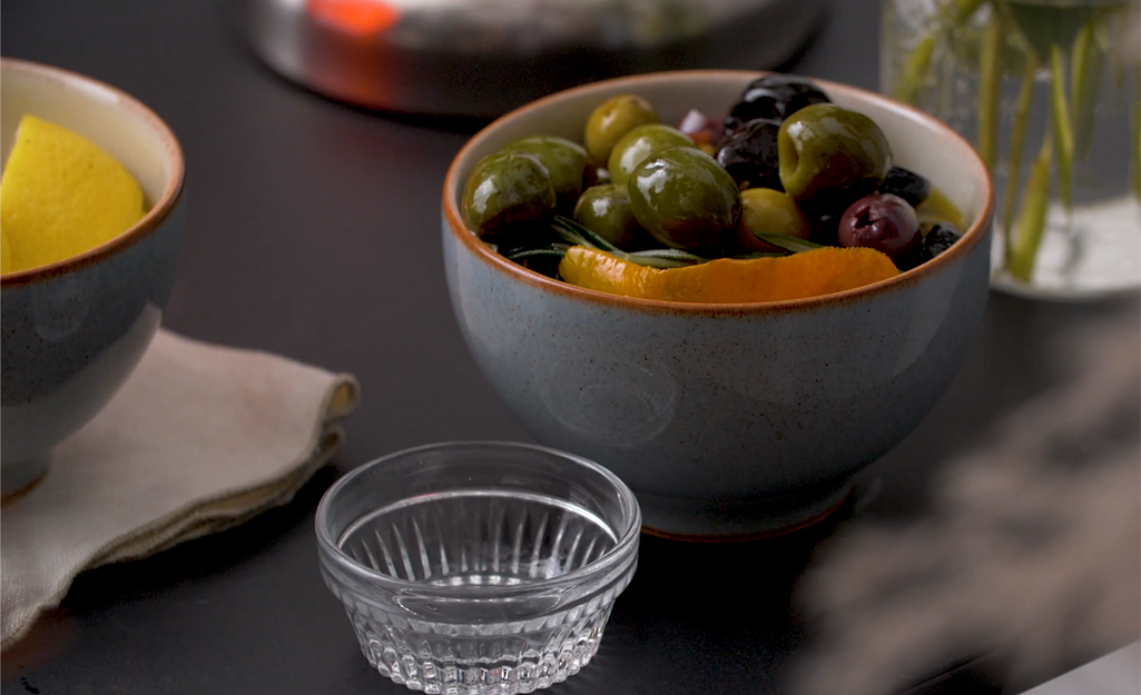 Bowl of olives next to a small glass bowl